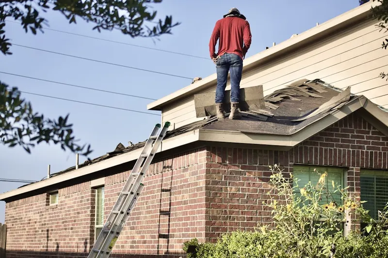 Professional roofer working on a residential roof in Wawaset Park